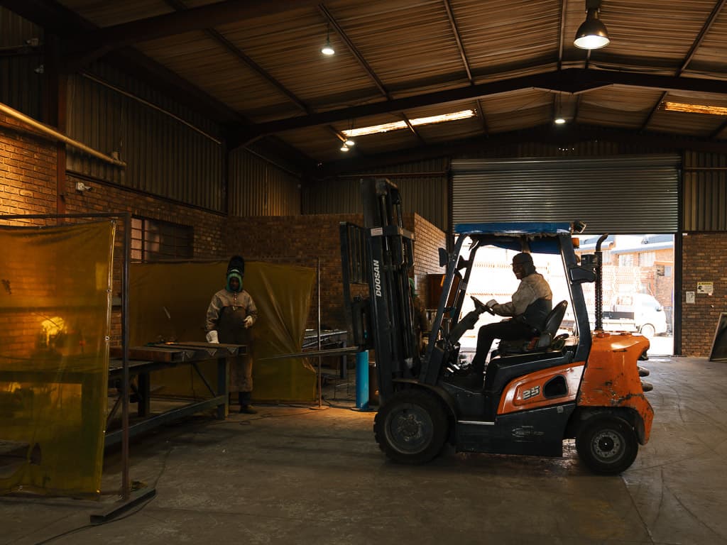 Forklift moving through the Foxtron Engineering workshop