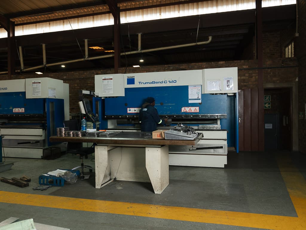 CNC press brake with bent parts on the bench