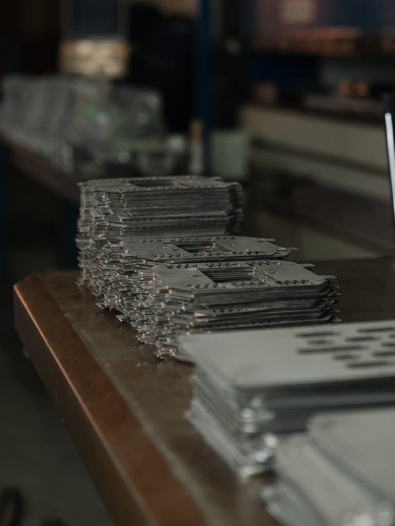 Stacks of precision laser-cut sheet metal parts